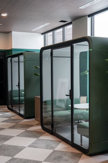A room with a black and white checkered floor and a green wall.