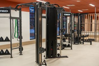 A gym with a TKO branded weight machine.