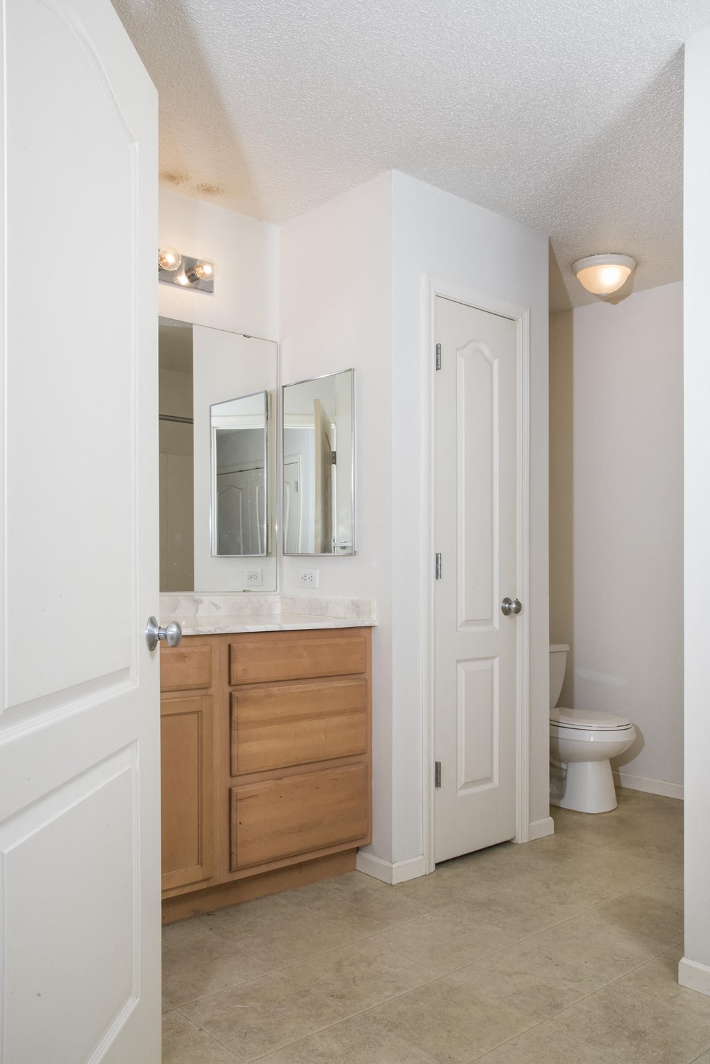 a bathroom with a toilet and a sink and a mirror
