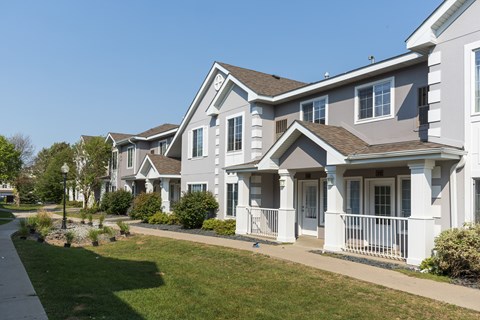 A row of houses with white and grey exteriors.