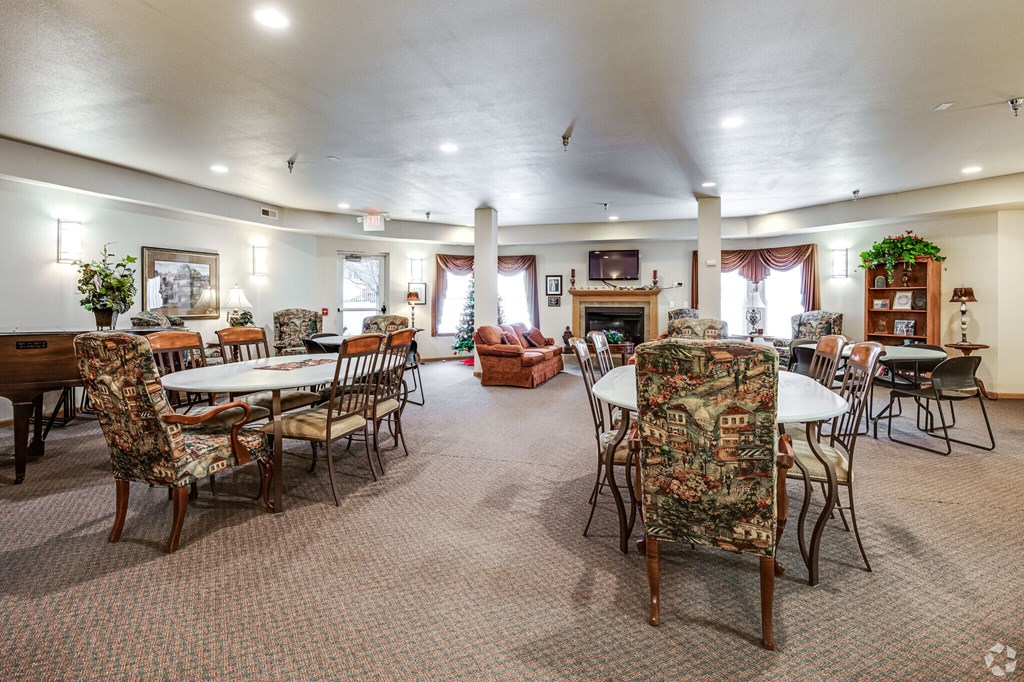 A large room with a dining table and chairs.