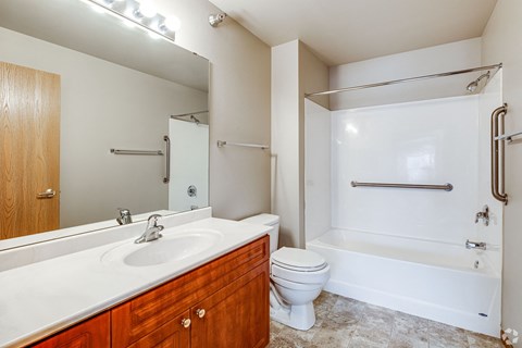 A bathroom with a toilet, sink, and bathtub.