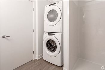 a white washer and dryer in a white laundry room