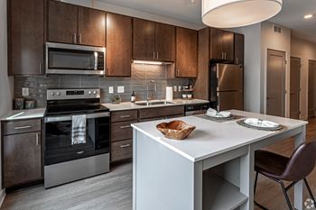 a kitchen with stainless steel appliances and a white counter top