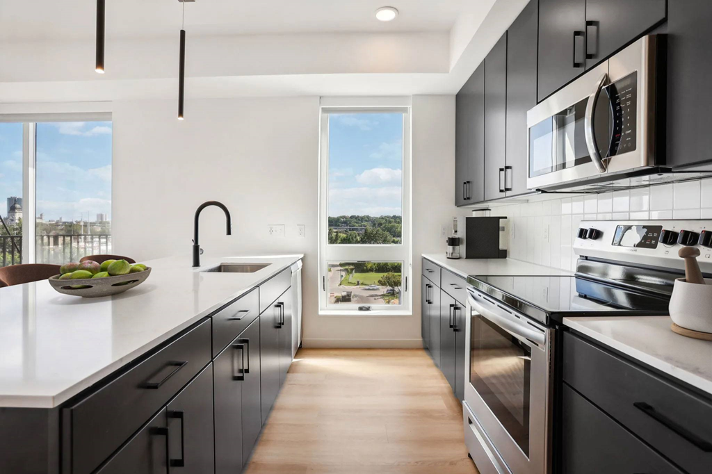 A modern kitchen with a view of the city.