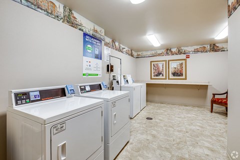 A laundromat with washers and dryers and a sign that says 