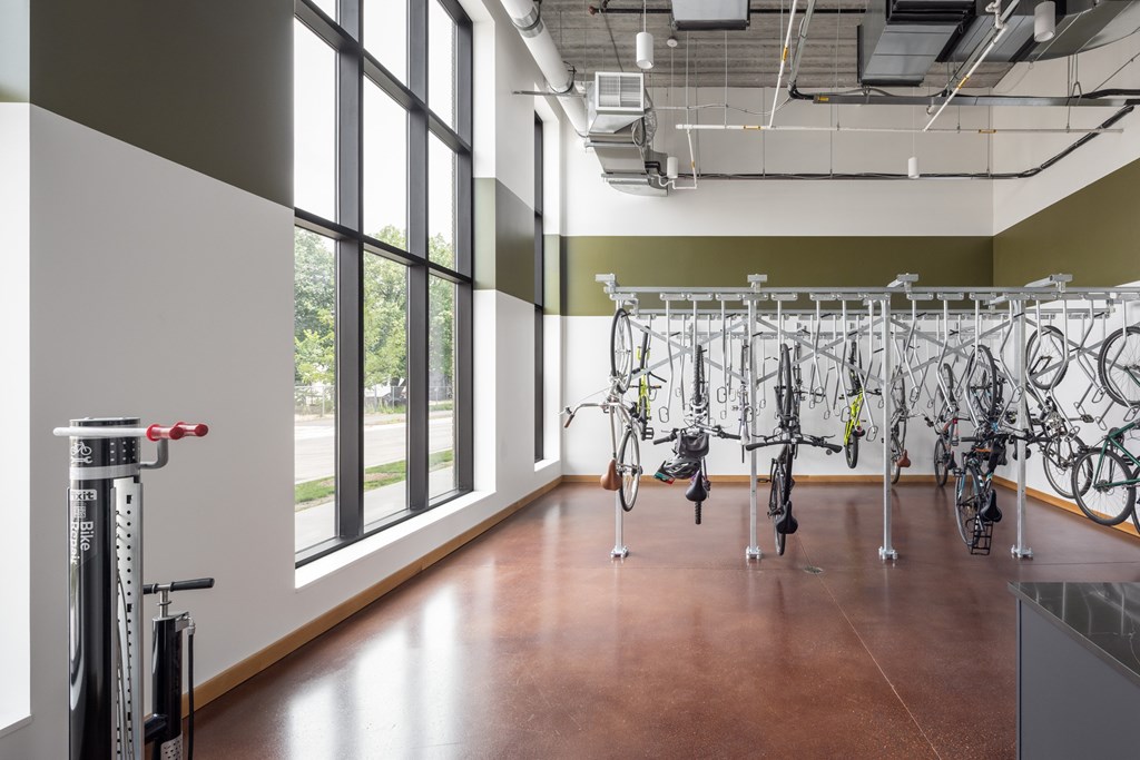 A bike rack with many bicycles hanging on it.