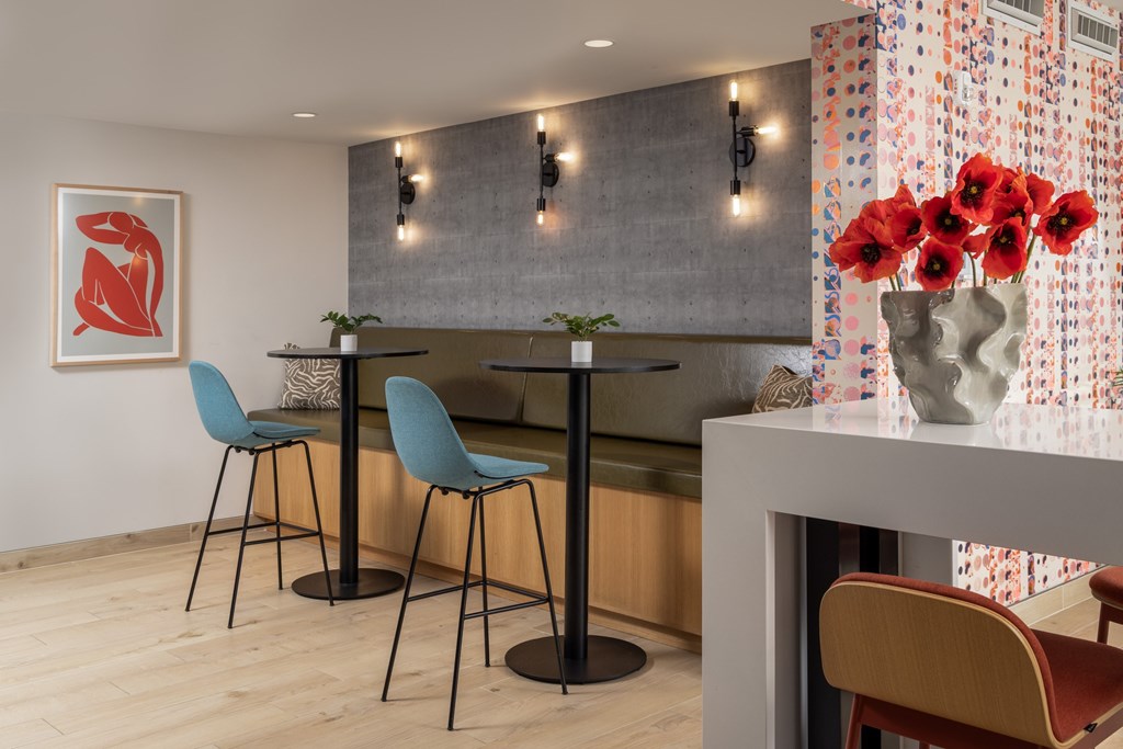 A dining area with a table and chairs.