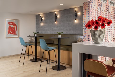A dining area with a table and chairs.