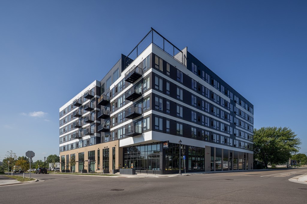 A modern multi-story building with a black and white facade.