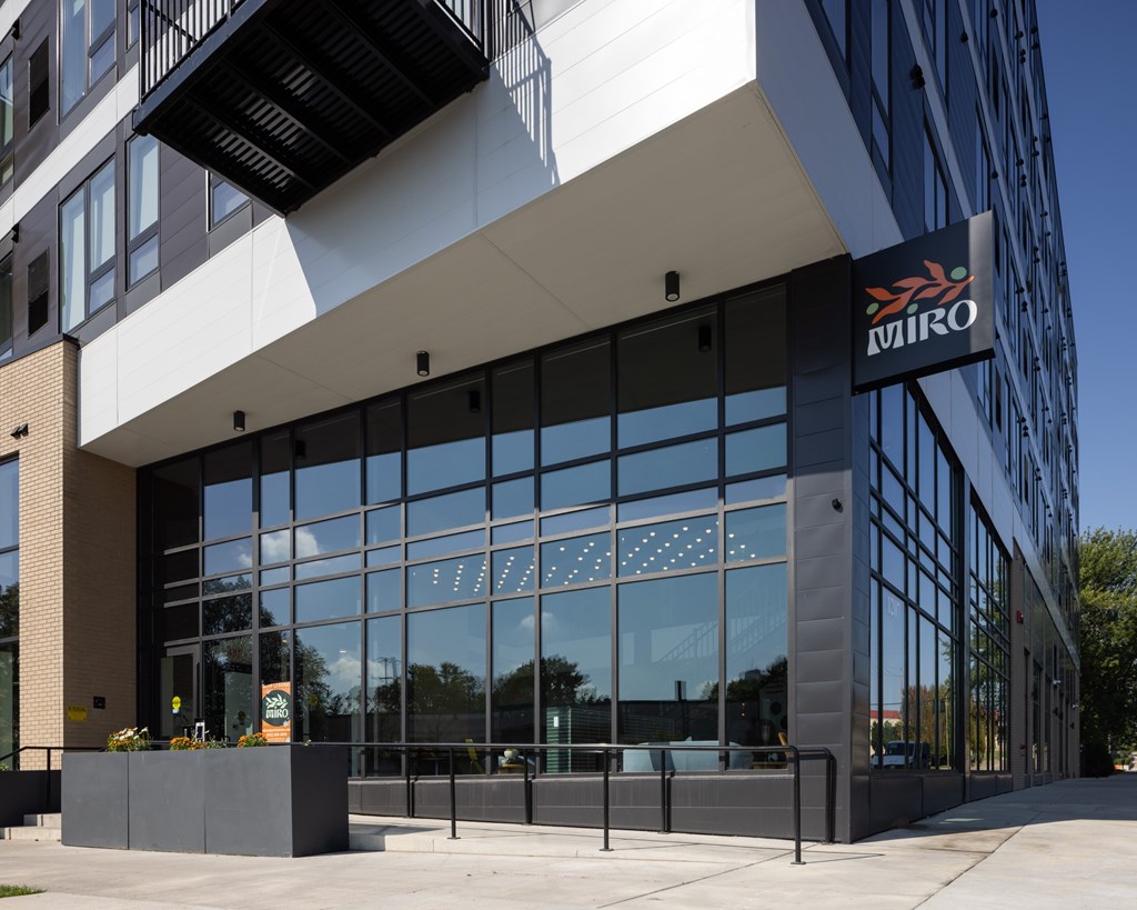 A modern building with a glass facade and a sign that reads "MIRO".