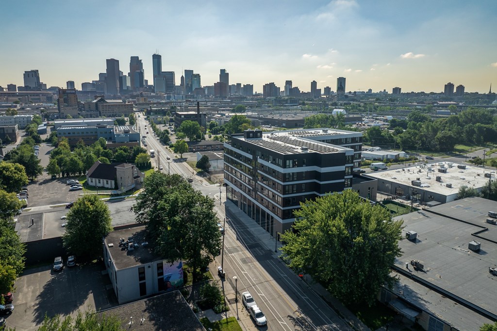 A cityscape with buildings and trees in the foreground.