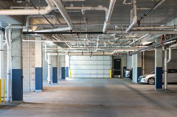 A parking garage with a car parked in the doorway.