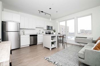 an open kitchen and living room with a large window