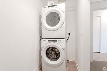 a washing machine and a dryer in a white room