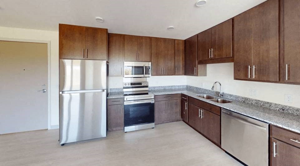 a kitchen with stainless steel appliances and wooden cabinets