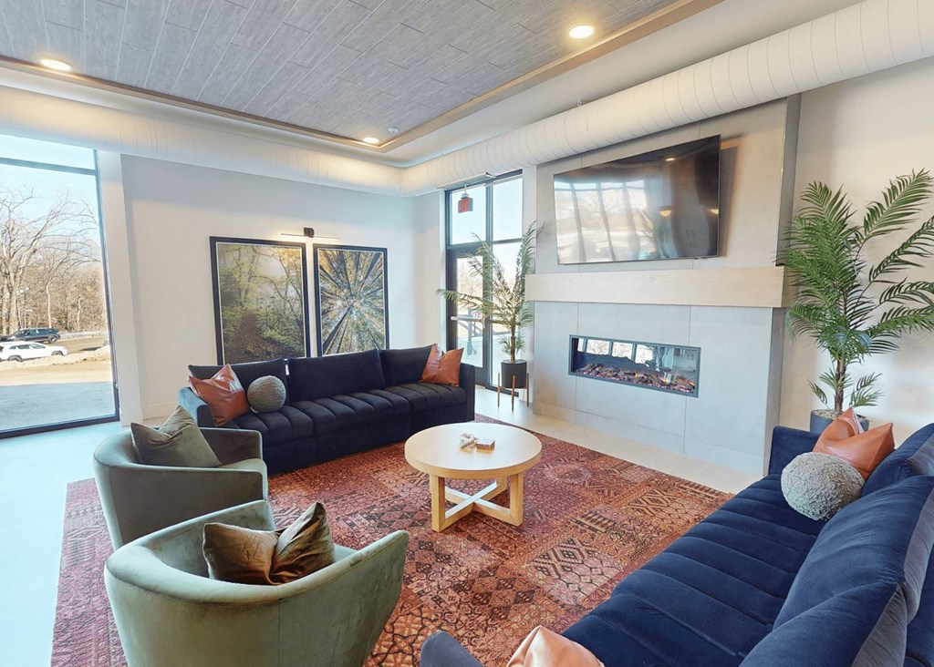 a living room with couches and chairs and a fireplace