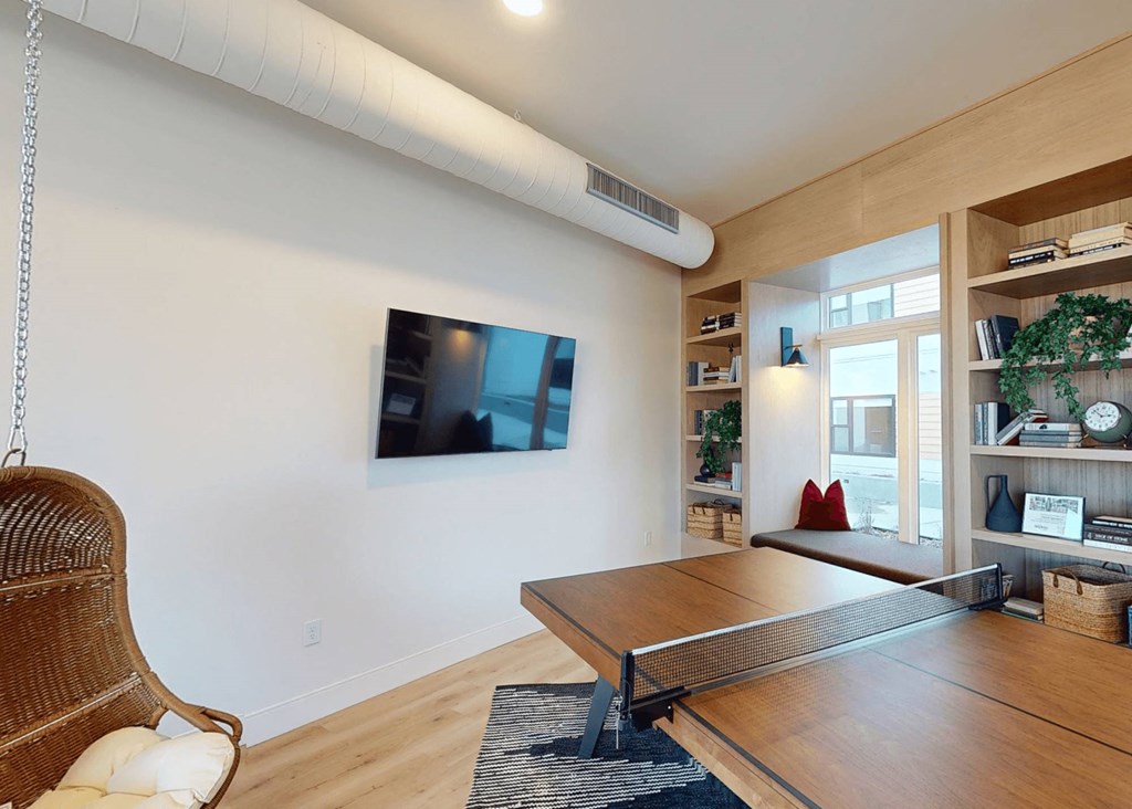 a living room with a table and a television
