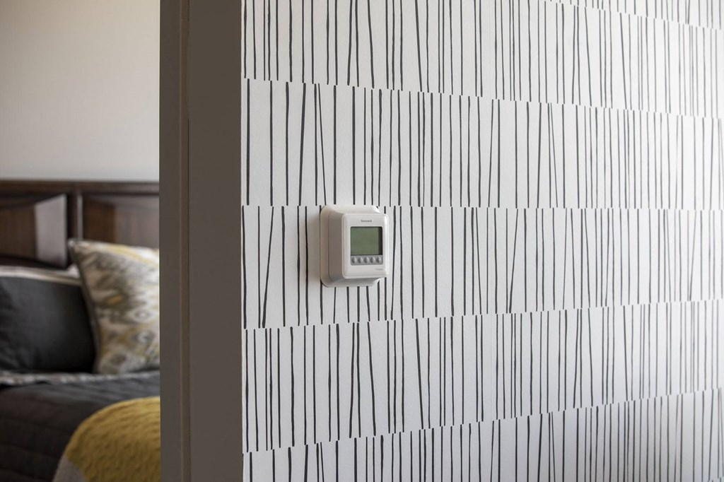 a thermometer on a wall with a geometric pattern