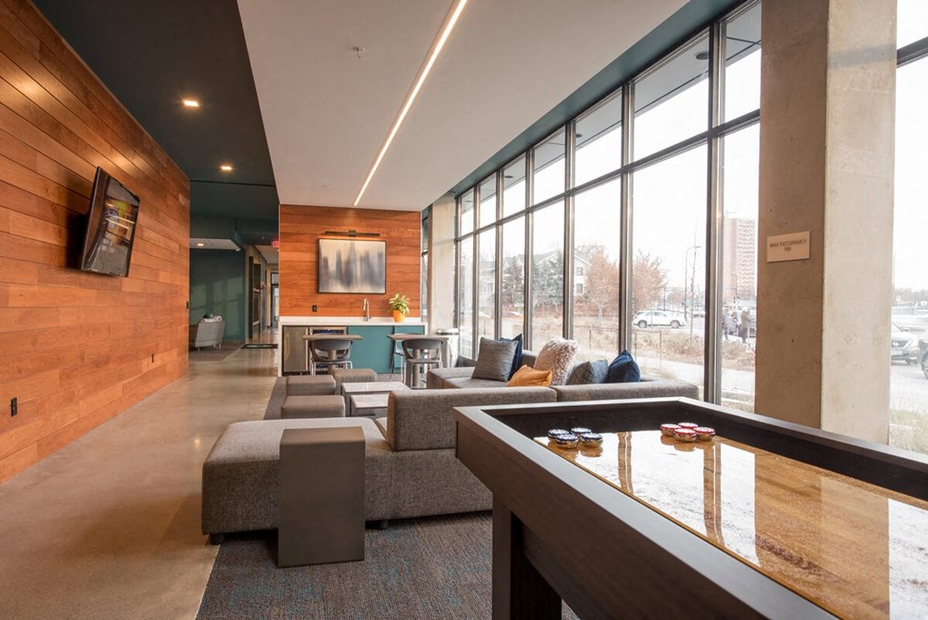 a living room with couches and a table    and a large window