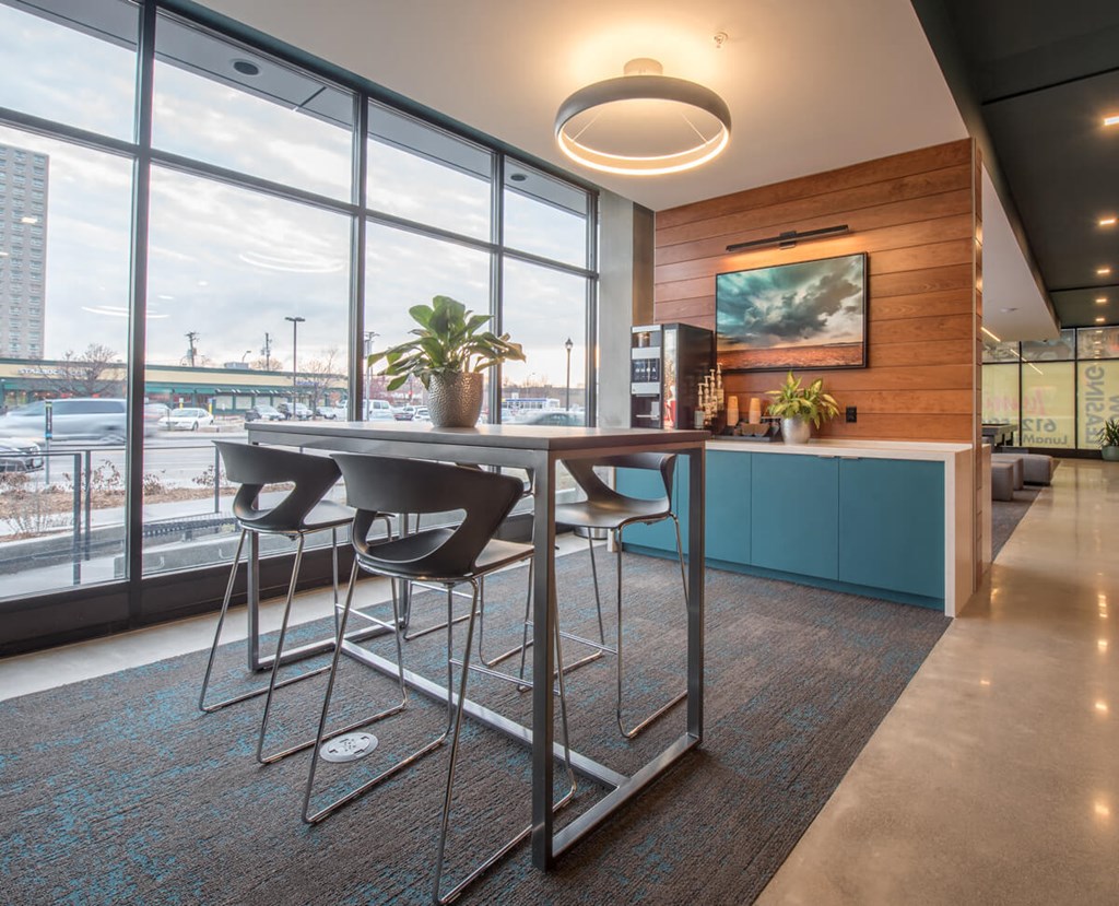 a bar with chairs in a room with a view