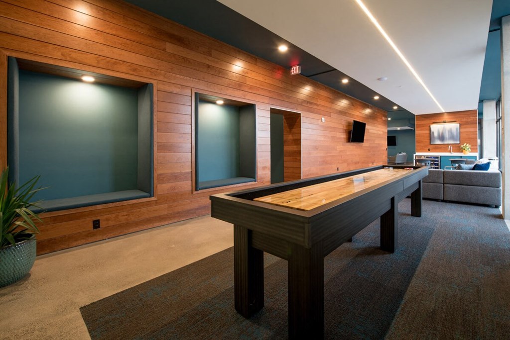 a game room with a pool table and a tv