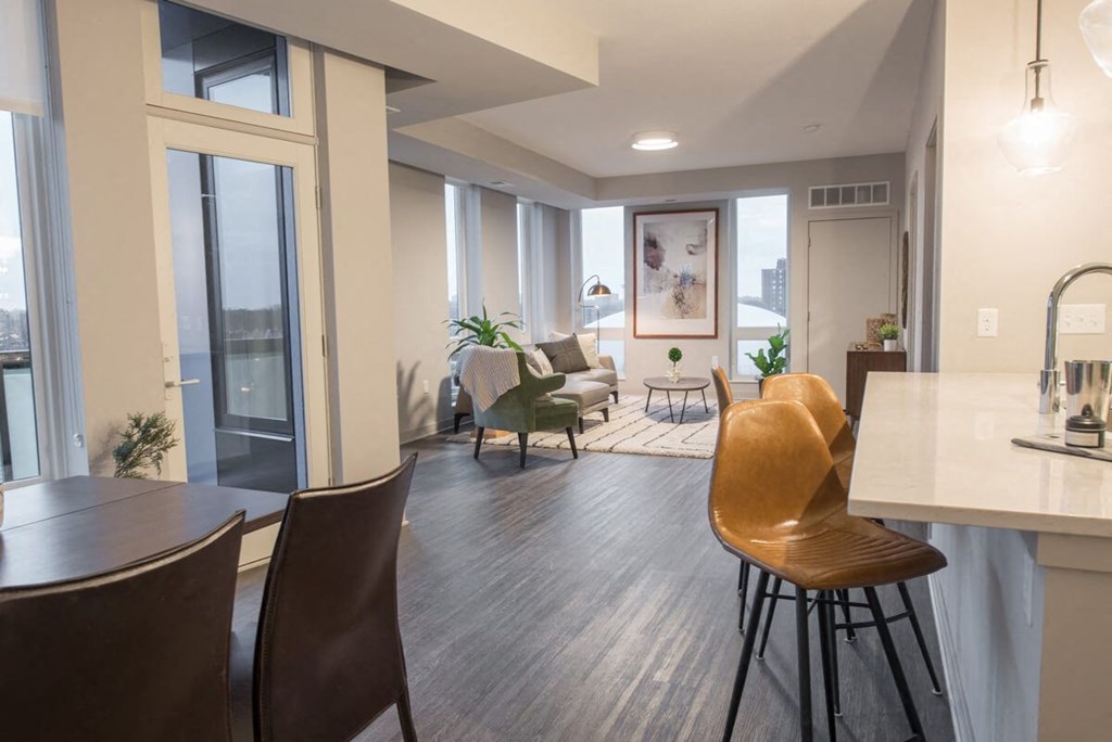 a living room and dining room with a table and chairs