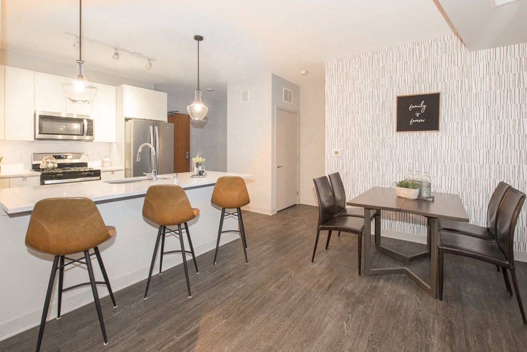 a dining room and kitchen with a table and chairs