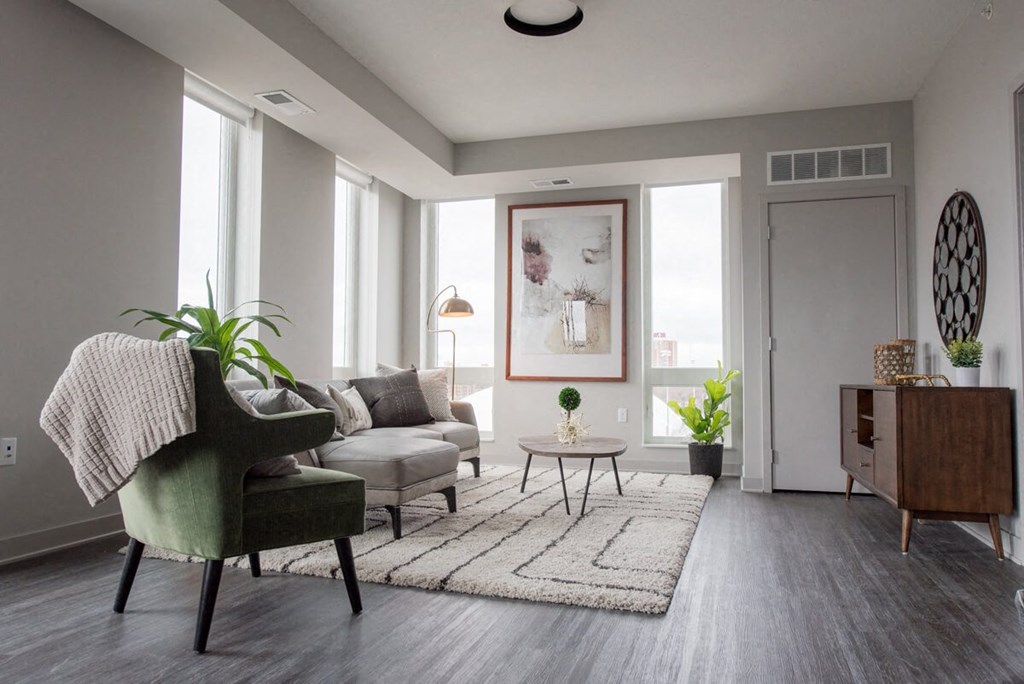 a living room with a couch and a chair and a rug