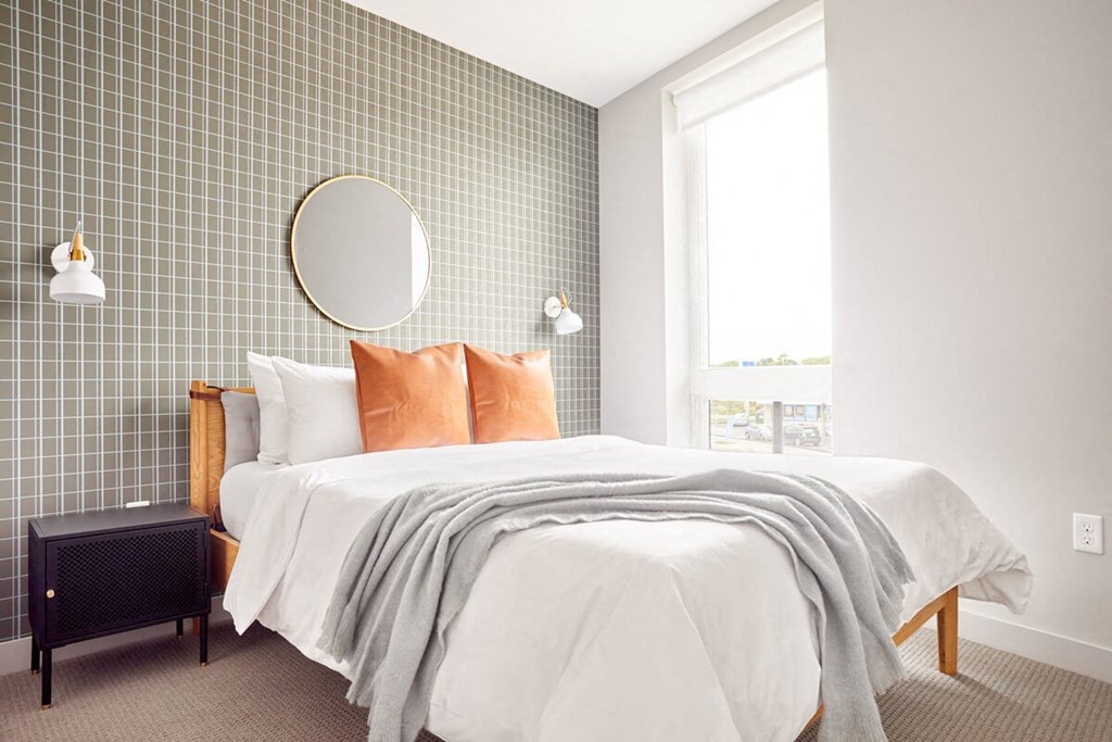 a bedroom with a bed and a mirror