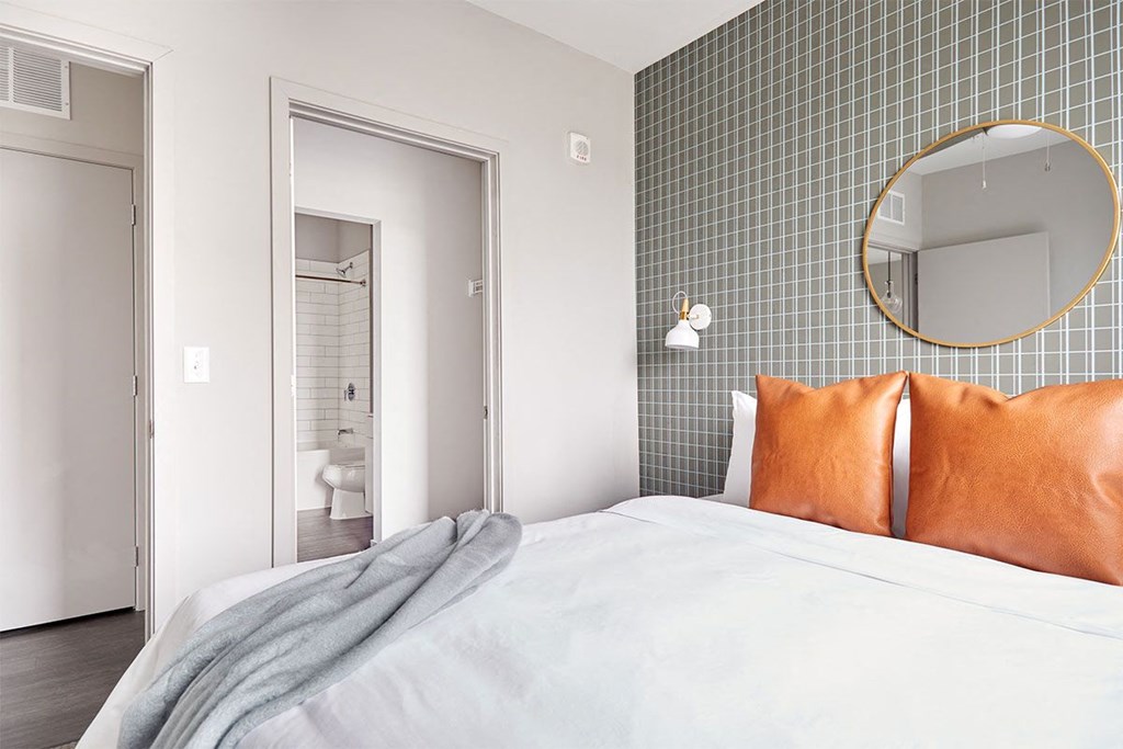 a bedroom with a bed and a mirror