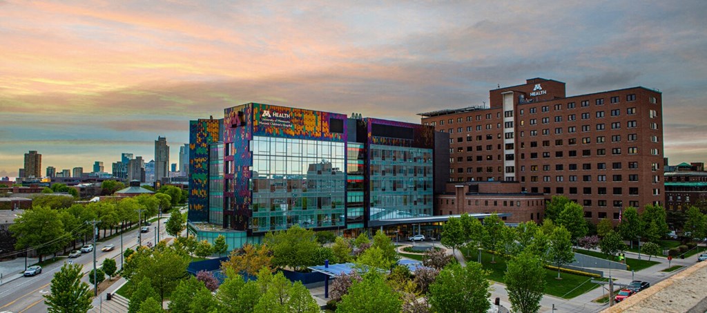 an aerial view of a building with a city in the background