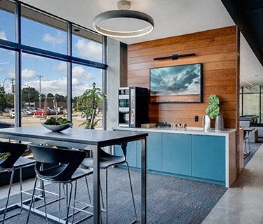 a kitchen with a table and chairs next to a window