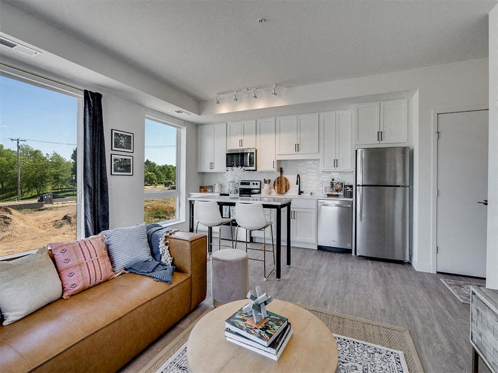a living room with a kitchen and a couch