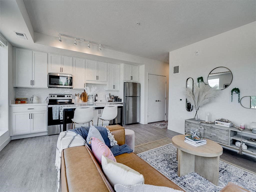 a living room with a kitchen and a couch