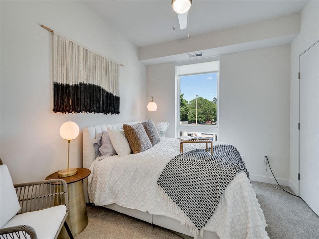 a bedroom with a bed and a window