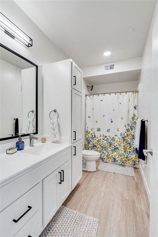 a bathroom with a toilet and a sink and a mirror