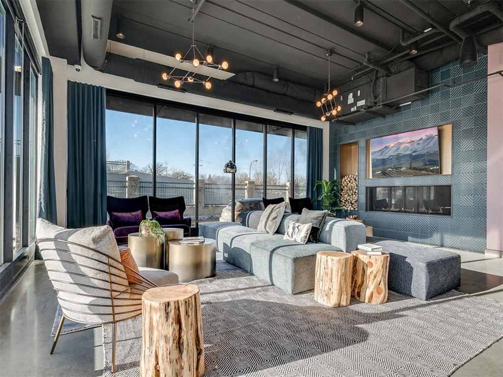 a living room with a large window and a couch and tables