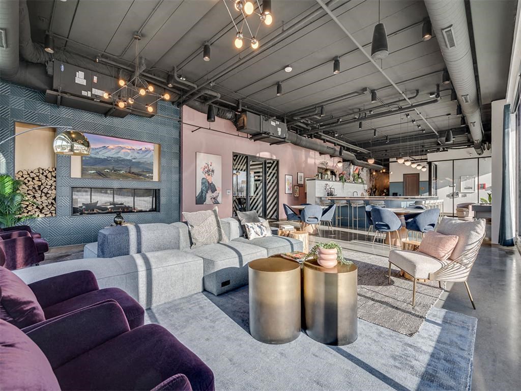 a living room with couches and chairs and a fireplace