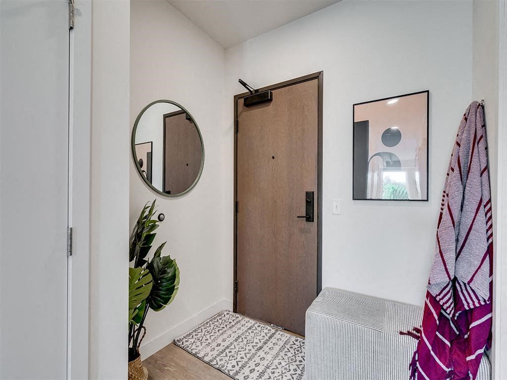 Woden door with a mirror and a rug