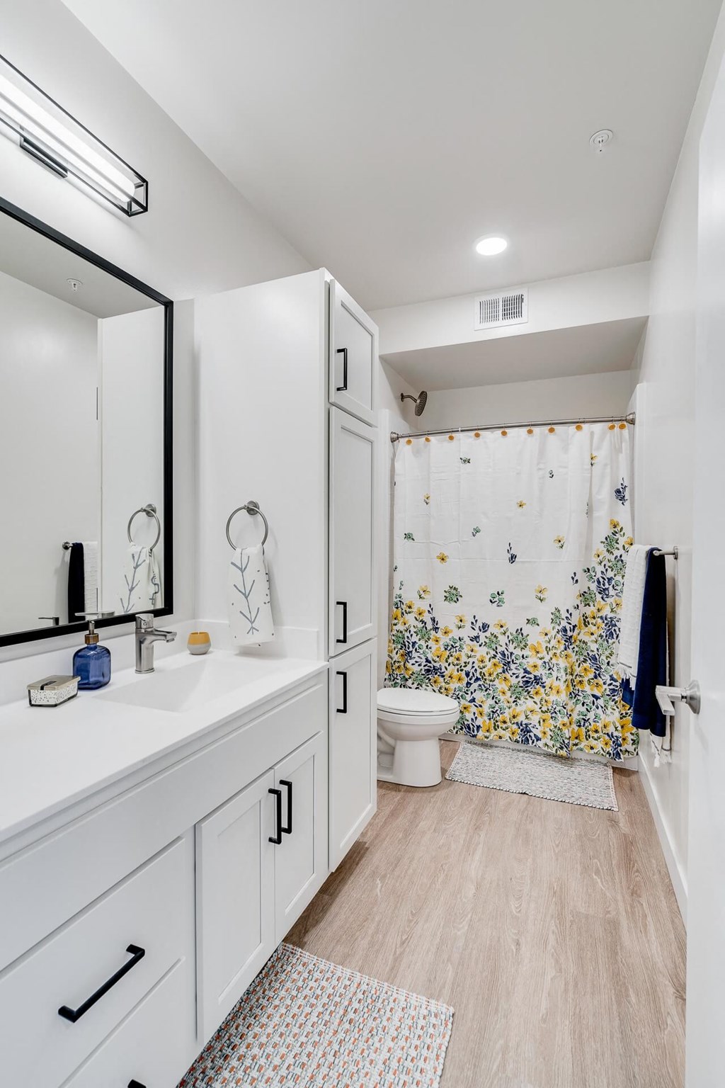 a white bathroom with a shower and a toilet