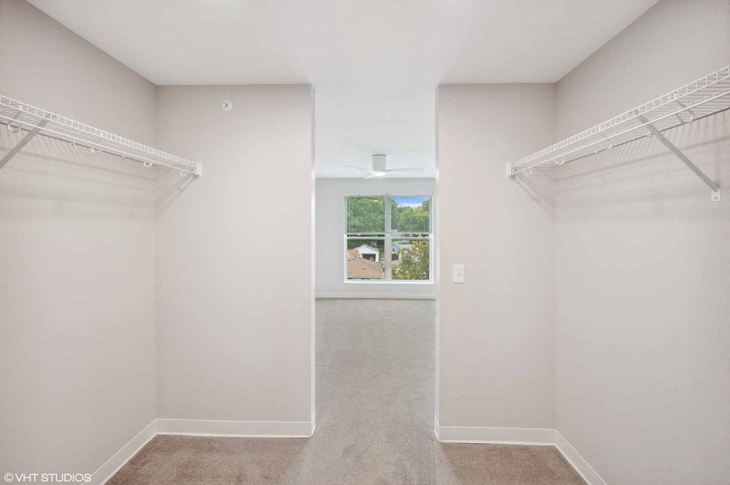 a room with two closets and a window in it