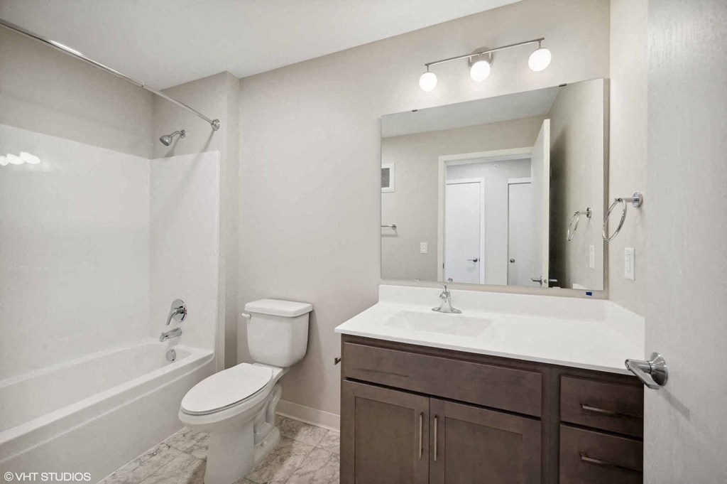 a bathroom with a sink toilet and a mirror