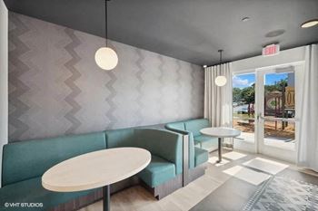 a waiting room with blue chairs and tables