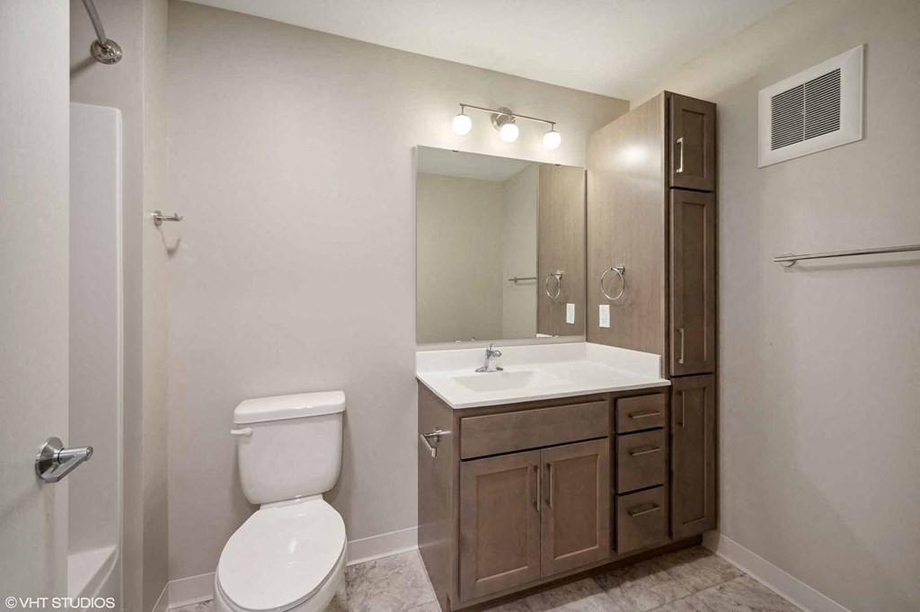a bathroom with a sink toilet and a mirror