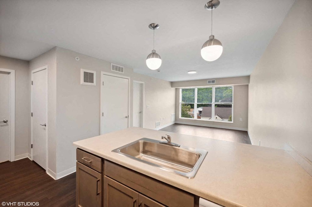 an empty kitchen with a sink and a window