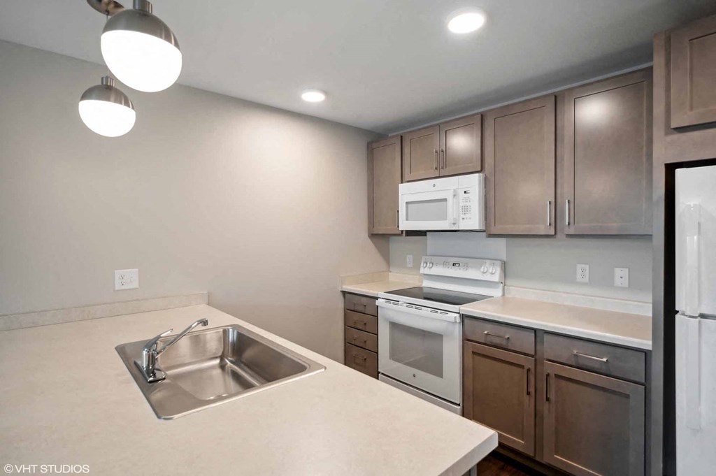 a kitchen with stainless steel appliances and a sink