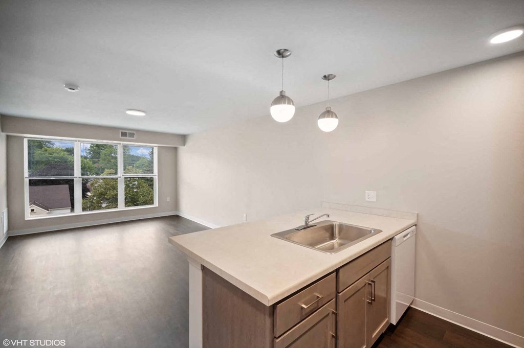 an empty kitchen with a sink and a window