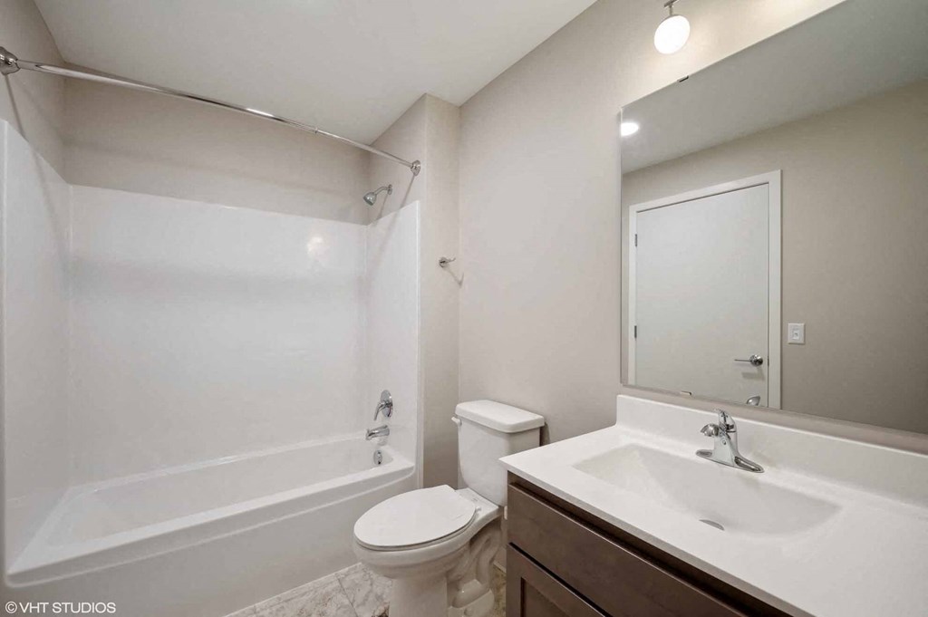 a bathroom with a sink toilet and a bath tub