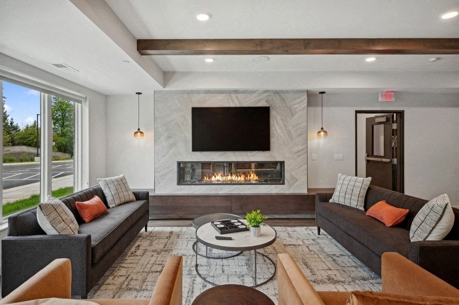 A modern living room with a fireplace and a flat screen TV.